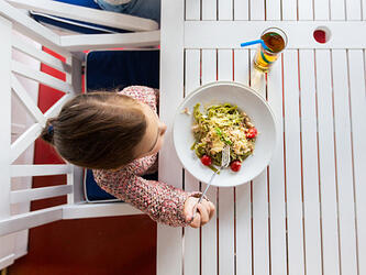 little girl eating dinner in restaurant
